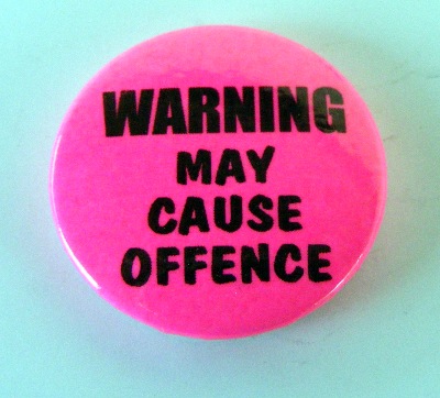 Insigna mica roz Warning May Cause Offence